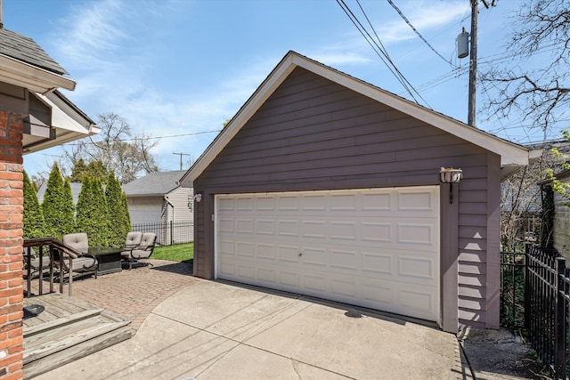 detached garage featuring fence