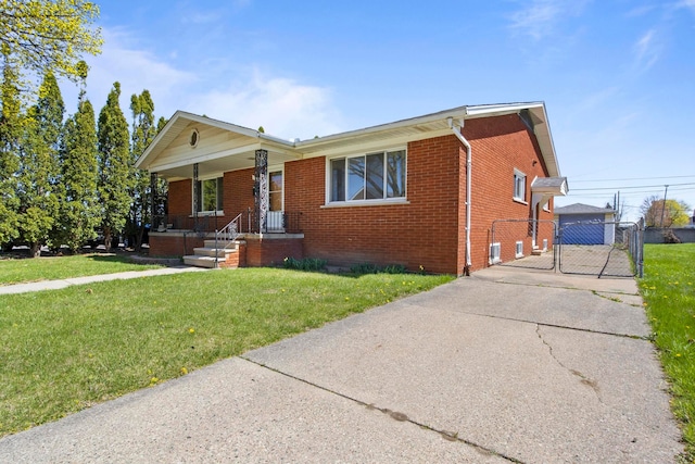 view of front of home with a front lawn, a gate, a porch, fence, and brick siding