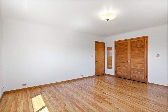unfurnished bedroom featuring baseboards and light wood-type flooring