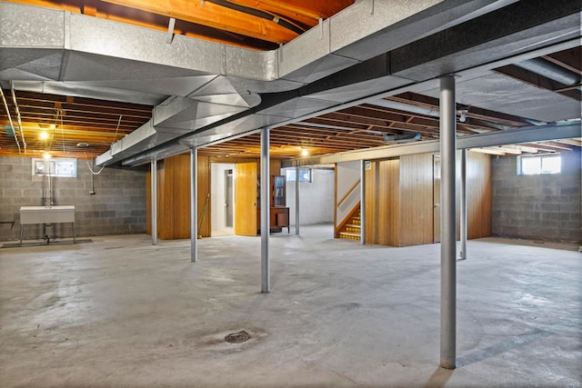 basement with stairway and a sink