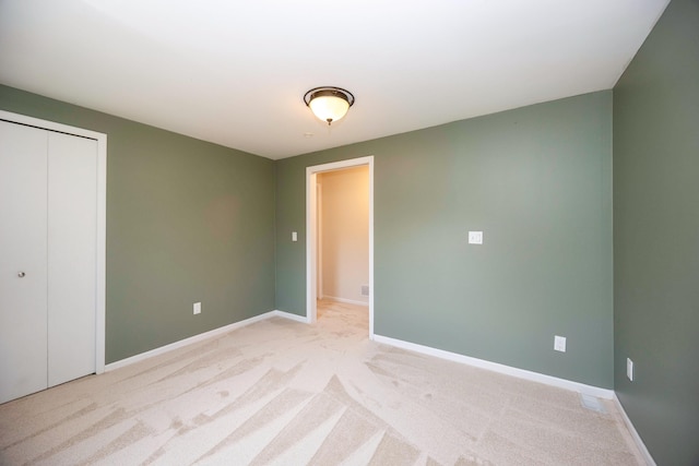2015 Rugby Ct, Ann Arbor, MI 48103 - unfurnished bedroom with baseboards, light colored carpet, and a closet