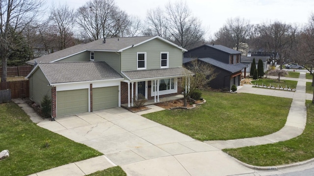 2015 Rugby Ct, Ann Arbor, MI 48103 - traditional home with roof with shingles, a porch, brick siding, an attached garage, and driveway