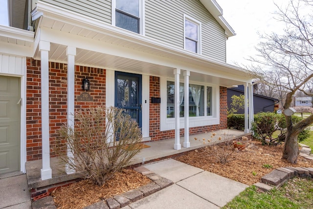 2015 Rugby Ct, Ann Arbor, MI 48103 - entrance to property featuring covered porch, brick siding, and a garage