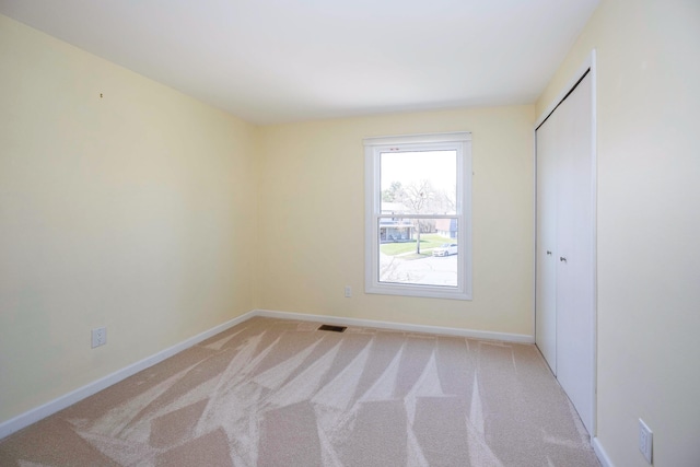 2015 Rugby Ct, Ann Arbor, MI 48103 - unfurnished bedroom with light colored carpet, baseboards, and a closet