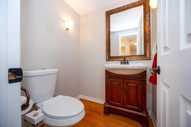 2015 Rugby Ct, Ann Arbor, MI 48103 - bathroom with wood finished floors, vanity, toilet, and baseboards