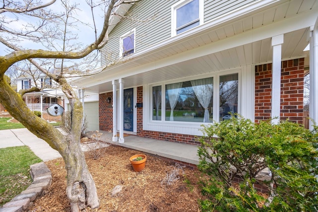 2015 Rugby Ct, Ann Arbor, MI 48103 - view of exterior entry featuring brick siding and a porch