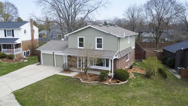 2015 Rugby Ct, Ann Arbor, MI 48103 - traditional-style house featuring a garage, concrete driveway, roof with shingles, brick siding, and cooling unit