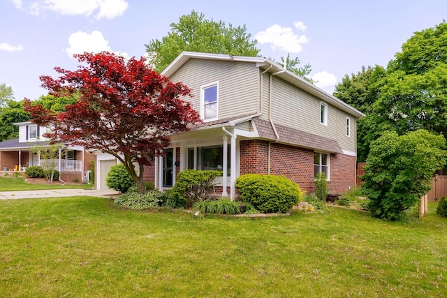 2015 Rugby Ct, Ann Arbor, MI 48103 - view of front of property featuring brick siding, a front yard, driveway, and a garage