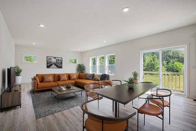 living area with light wood-style flooring and recessed lighting