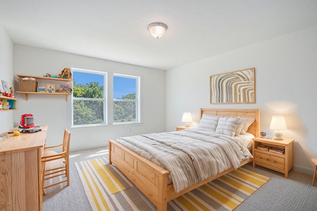 bedroom featuring light carpet and baseboards