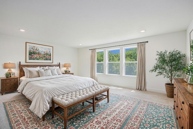 bedroom with light carpet and recessed lighting