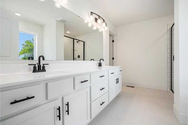 bathroom with a shower stall, a sink, visible vents, and double vanity