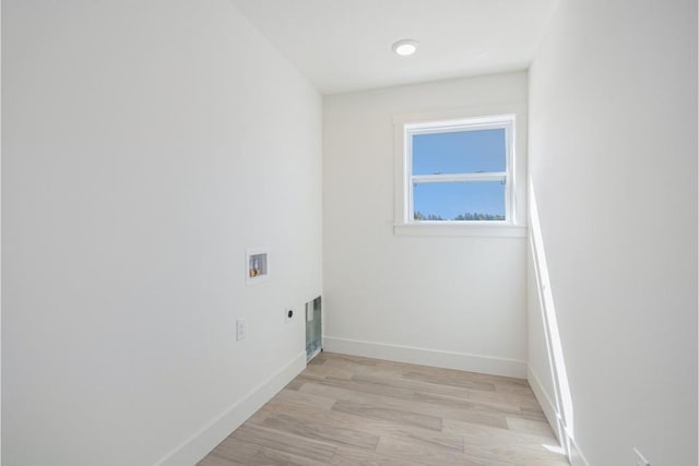 washroom with baseboards, light wood-style floors, washer hookup, electric dryer hookup, and laundry area