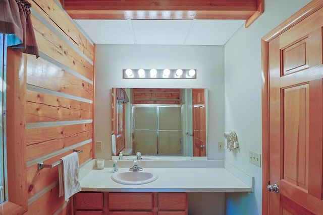 bathroom with a shower stall and vanity