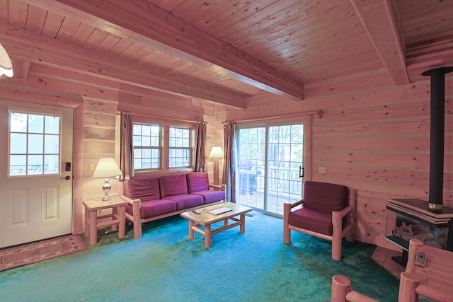 carpeted living area with beamed ceiling, wood ceiling, wooden walls, and a wood stove