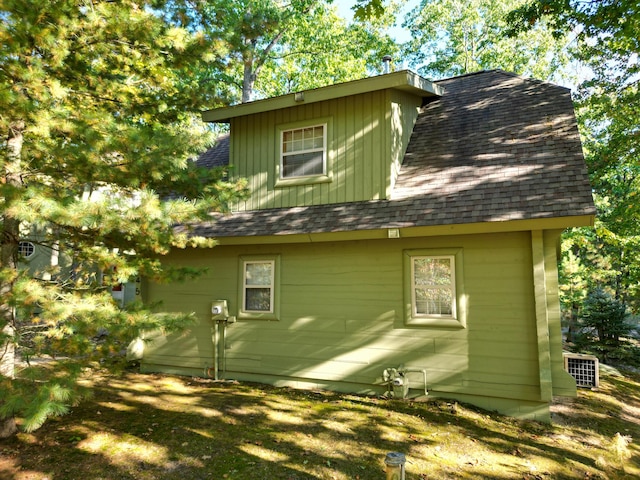 back of property featuring a shingled roof and central air condition unit