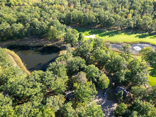 birds eye view of property featuring a wooded view and a water view