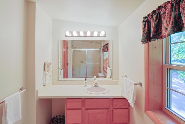 bathroom with vaulted ceiling, a shower stall, toilet, and vanity