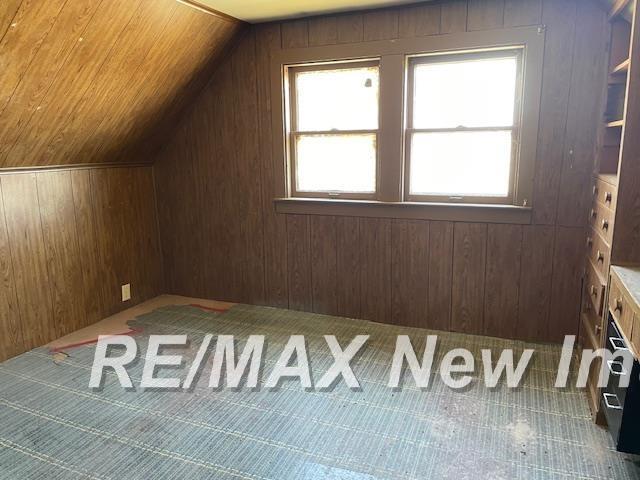 5225 N Vassar Rd, Akron, MI 48701 - bonus room featuring vaulted ceiling and wood walls