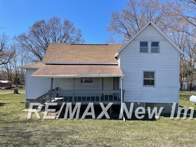 5225 N Vassar Rd, Akron, MI 48701 - rear view of house featuring a lawn, a shingled roof, and covered porch
