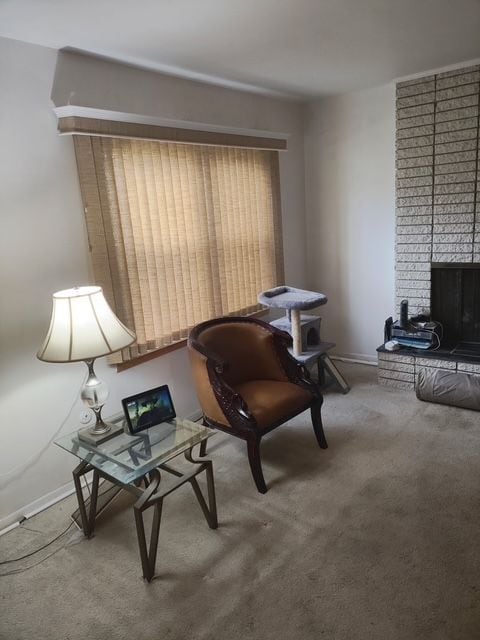 6689 Andersonville Rd Unit 29, Clarkston, MI 48346 - living area with carpet floors, a fireplace, and baseboards