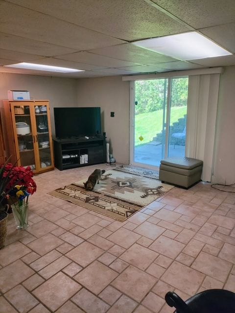 6689 Andersonville Rd Unit 29, Clarkston, MI 48346 - living area with brick patterned floors and a drop ceiling