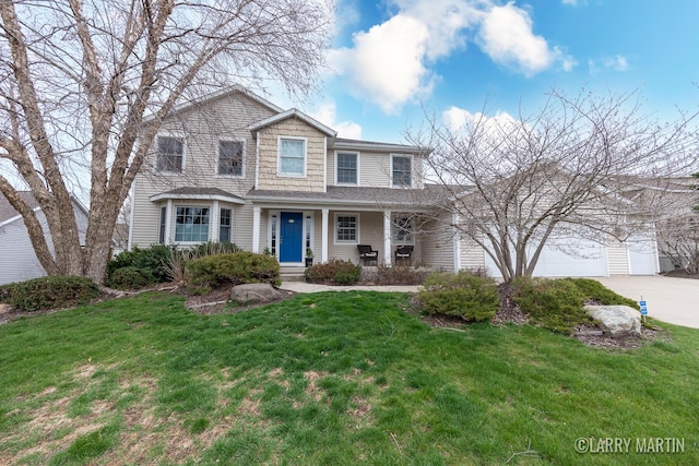 traditional-style home with covered porch, a front lawn, and concrete driveway