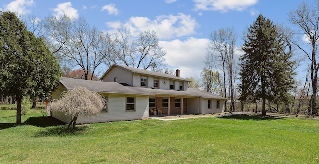 2050 Rowe Rd, Milford, MI 48380 - rear view of house with a chimney and a yard