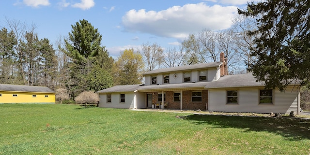 2050 Rowe Rd, Milford, MI 48380 - rear view of property with a yard, a chimney, and brick siding