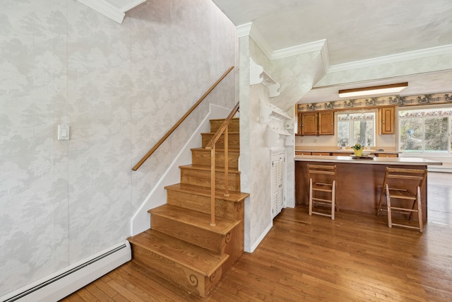 2050 Rowe Rd, Milford, MI 48380 - staircase with crown molding, wood-type flooring, and a baseboard heating unit