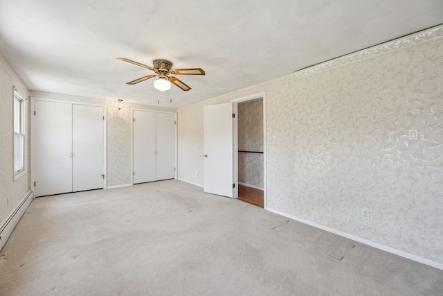 2050 Rowe Rd, Milford, MI 48380 - unfurnished bedroom featuring light carpet, a ceiling fan, wallpapered walls, and a baseboard heating unit