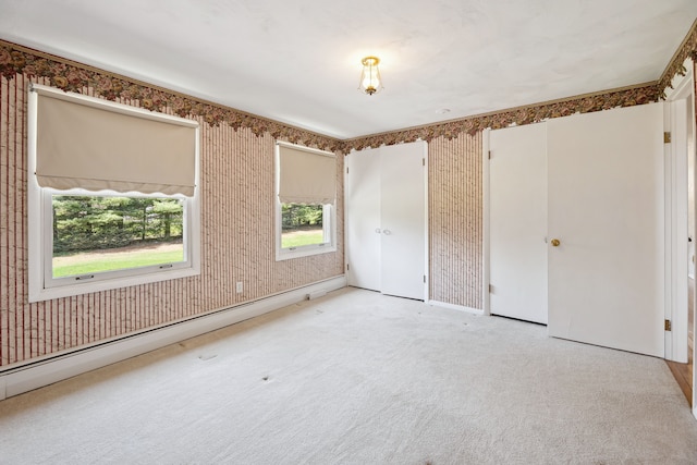 2050 Rowe Rd, Milford, MI 48380 - unfurnished room with a baseboard radiator, light carpet, and wallpapered walls