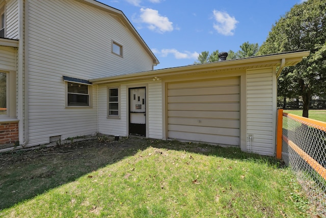 2050 Rowe Rd, Milford, MI 48380 - rear view of property featuring an attached garage, fence, driveway, and a lawn