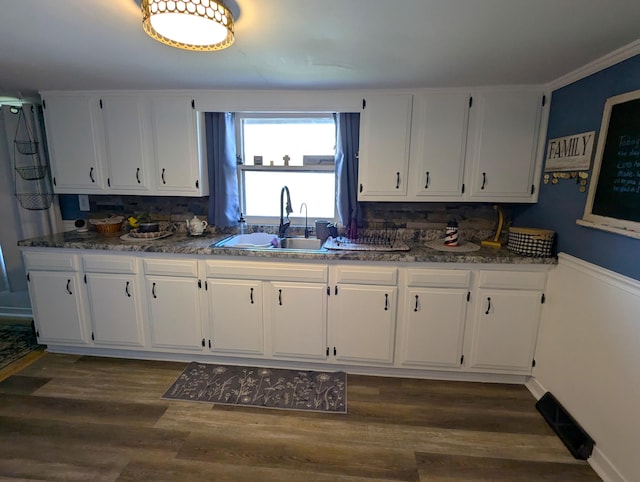kitchen featuring dark wood-style floors, white cabinetry, and a sink