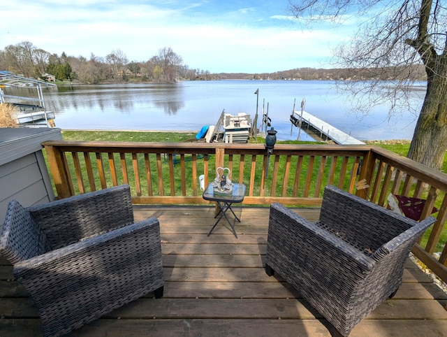 wooden terrace featuring a yard, a boat dock, a water view, and boat lift