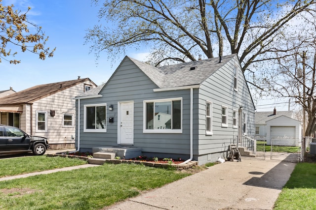28320 Hillview St, Roseville, MI 48066 - bungalow-style house with a shingled roof, driveway, a front yard, and a detached garage
