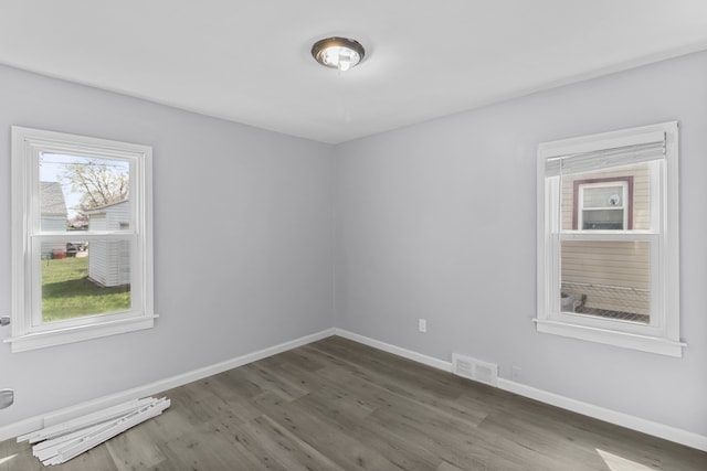 28320 Hillview St, Roseville, MI 48066 - unfurnished room featuring baseboards, wood finished floors, visible vents, and a wealth of natural light