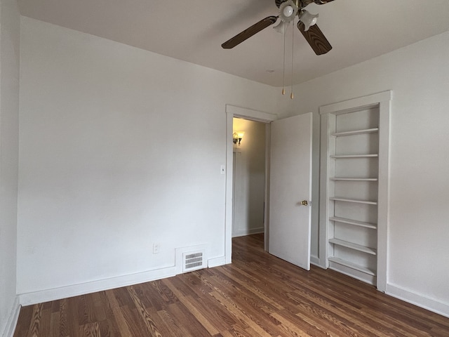 26741 Dartmouth St, Madison Heights, MI 48071 - unfurnished bedroom with dark wood-style flooring, baseboards, and ceiling fan