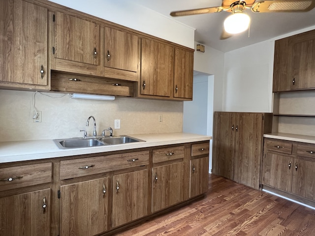 26741 Dartmouth St, Madison Heights, MI 48071 - kitchen with a sink, wood finished floors, light countertops, and ceiling fan