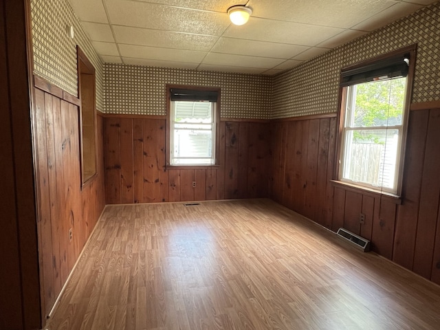 26741 Dartmouth St, Madison Heights, MI 48071 - unfurnished room featuring wallpapered walls, wood finished floors, plenty of natural light, and a wainscoted wall