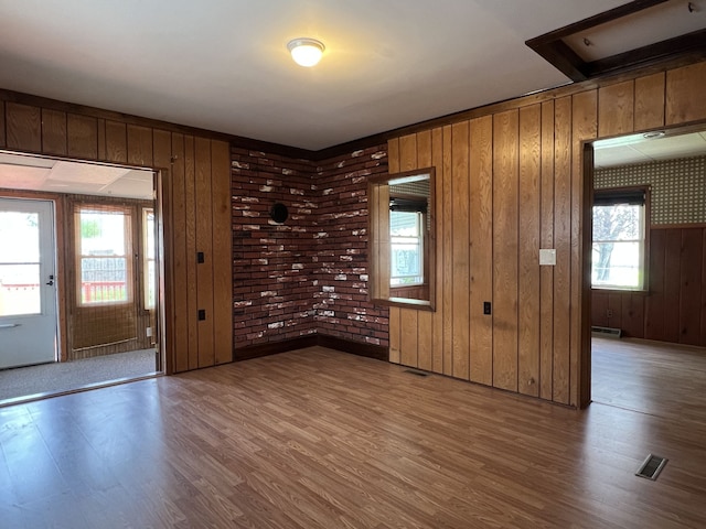 26741 Dartmouth St, Madison Heights, MI 48071 - spare room featuring wood finished floors, wooden walls, and baseboard heating