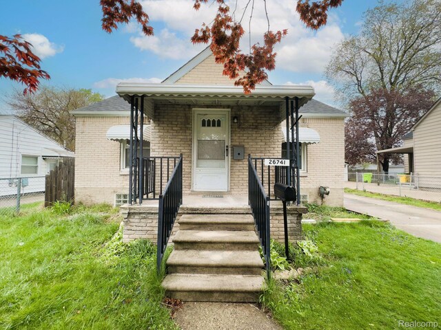 26741 Dartmouth St, Madison Heights, MI 48071 - bungalow-style home with a porch and brick siding