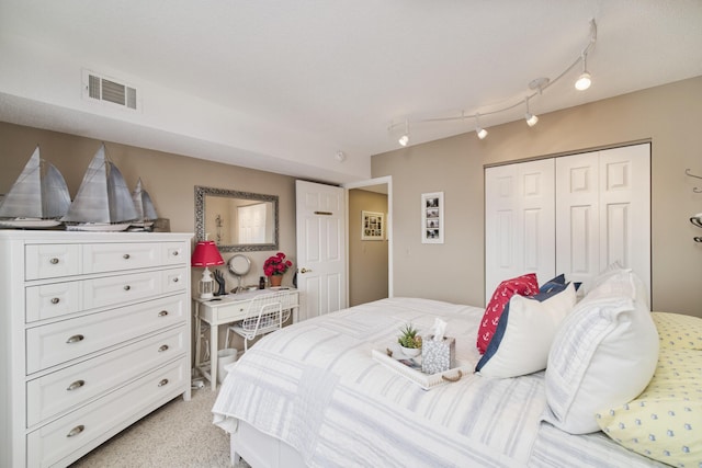 bedroom with visible vents and a closet