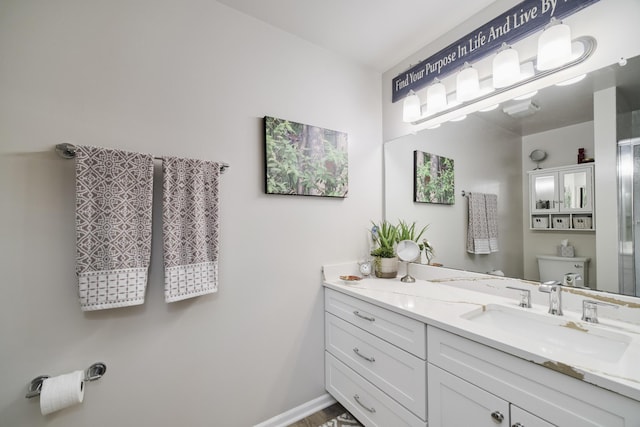 full bathroom featuring a shower with shower door, baseboards, toilet, and vanity