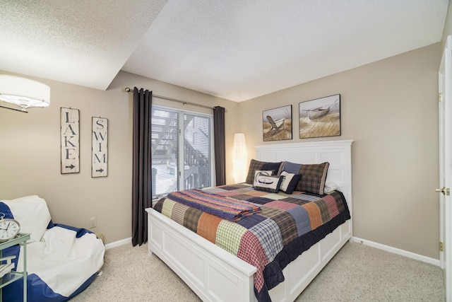 bedroom featuring baseboards, a textured ceiling, and light colored carpet