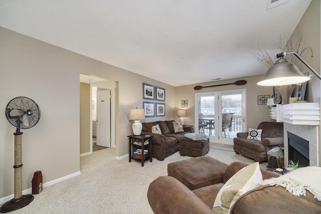 living room with baseboards, carpet flooring, and a fireplace