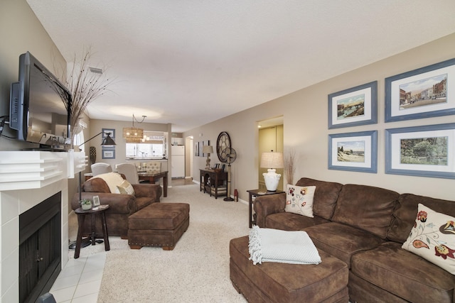 living room featuring light carpet and a tile fireplace