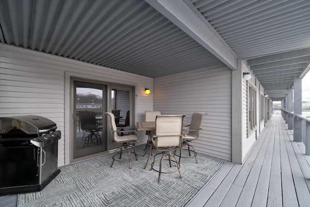 deck with grilling area and outdoor dining area