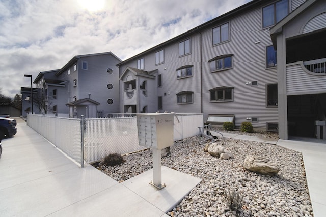 exterior space with fence and mail area