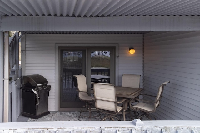 wooden deck featuring grilling area and outdoor dining space
